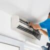 Waynes Wholesale Spares - Technician Repairing an Air Conditioner